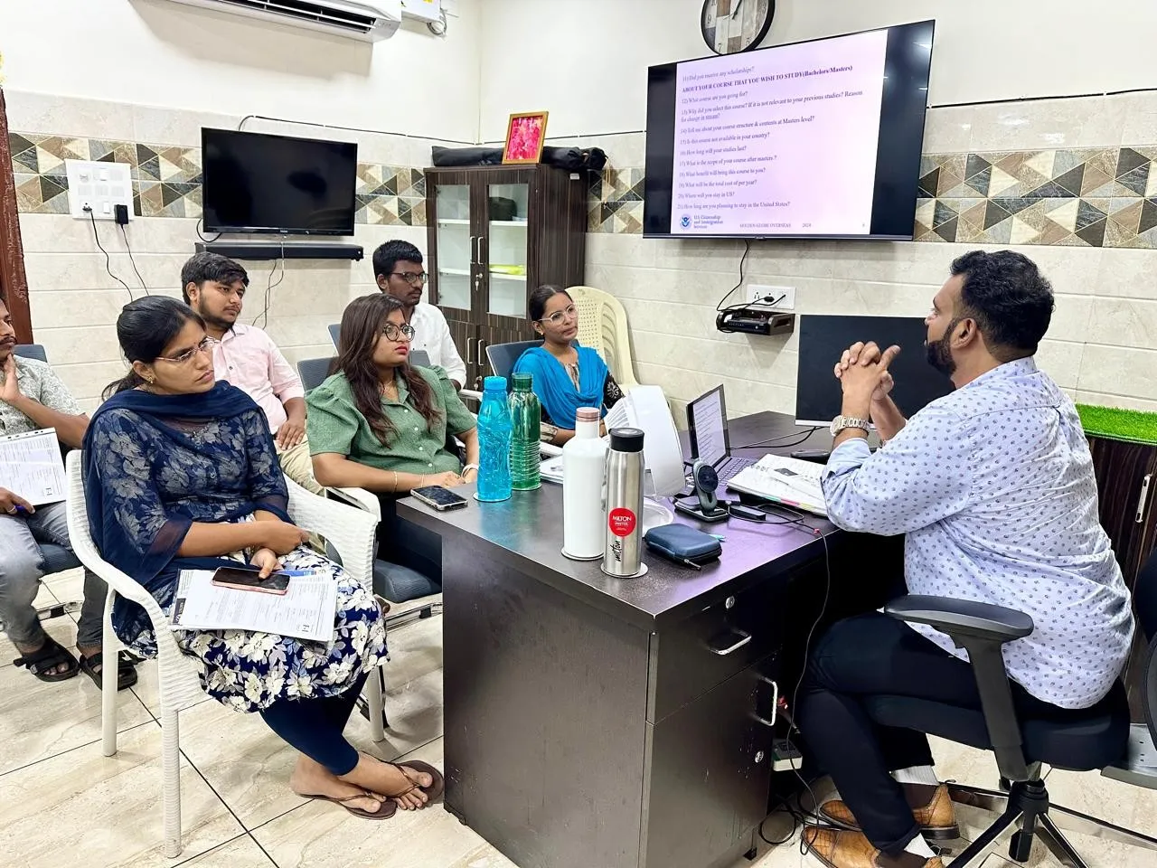 A counsellor preparing students for their visa interview